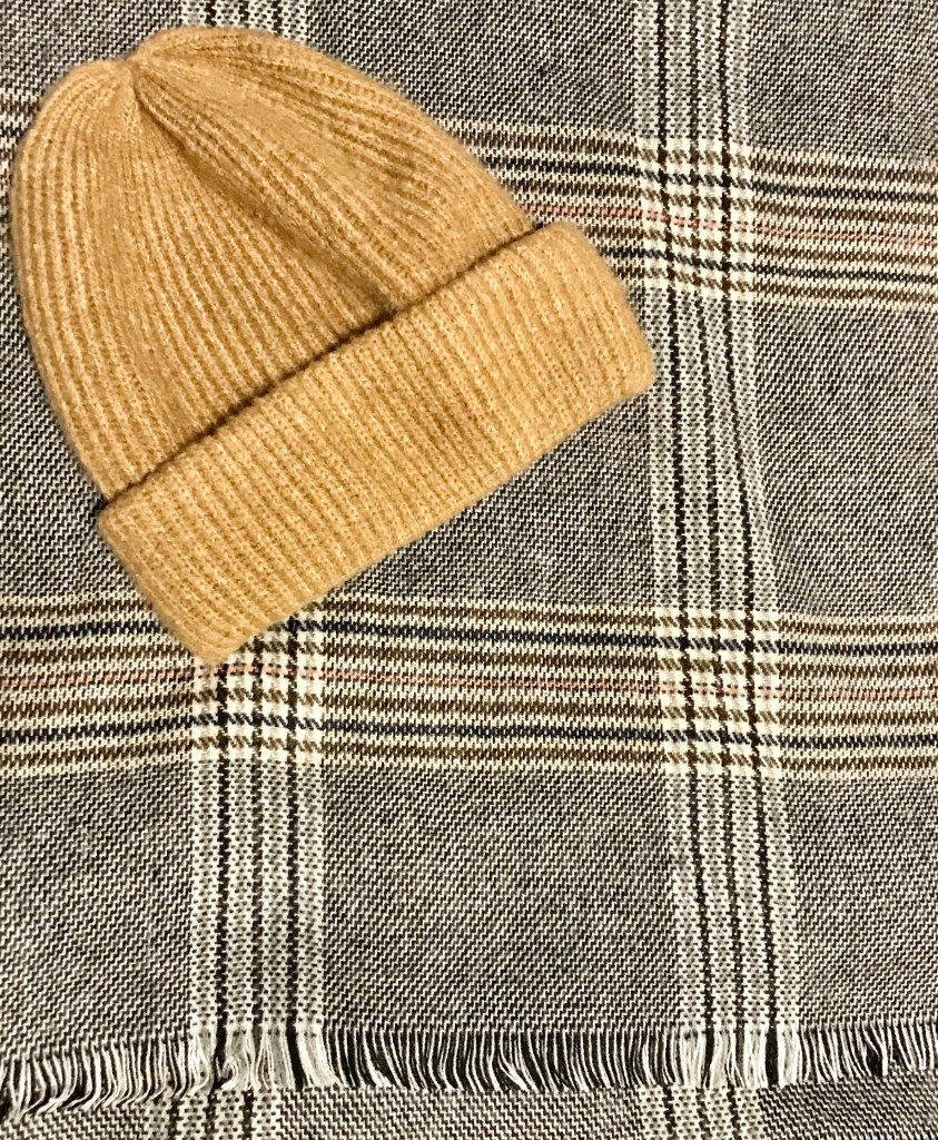 brown/beige hat, scraf plaid black and white with pink, blue and brown colour throughout